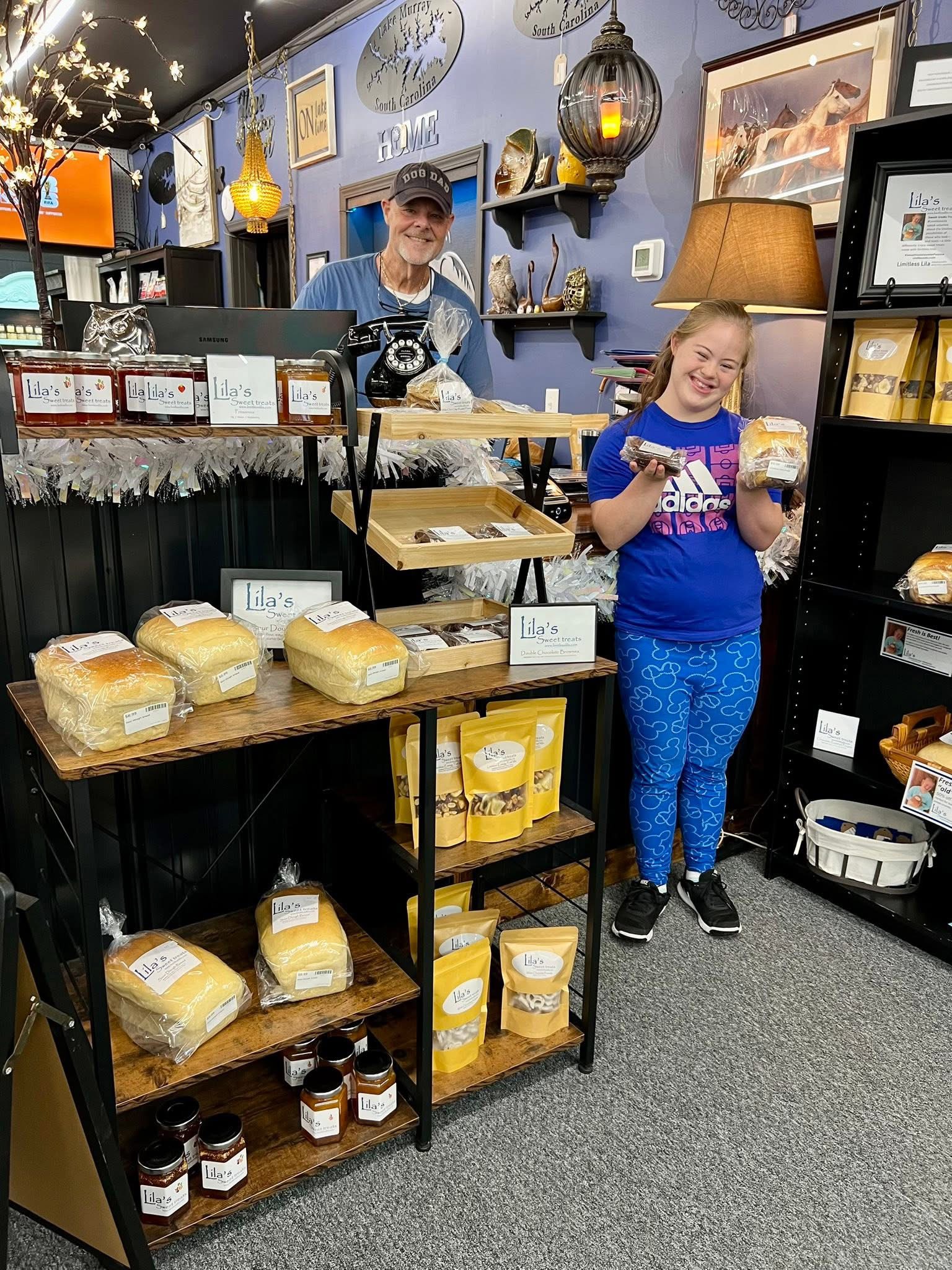 Vendor booth filled with vintage home decor, furniture, and accessories, including lamps, artwork, and dishes.