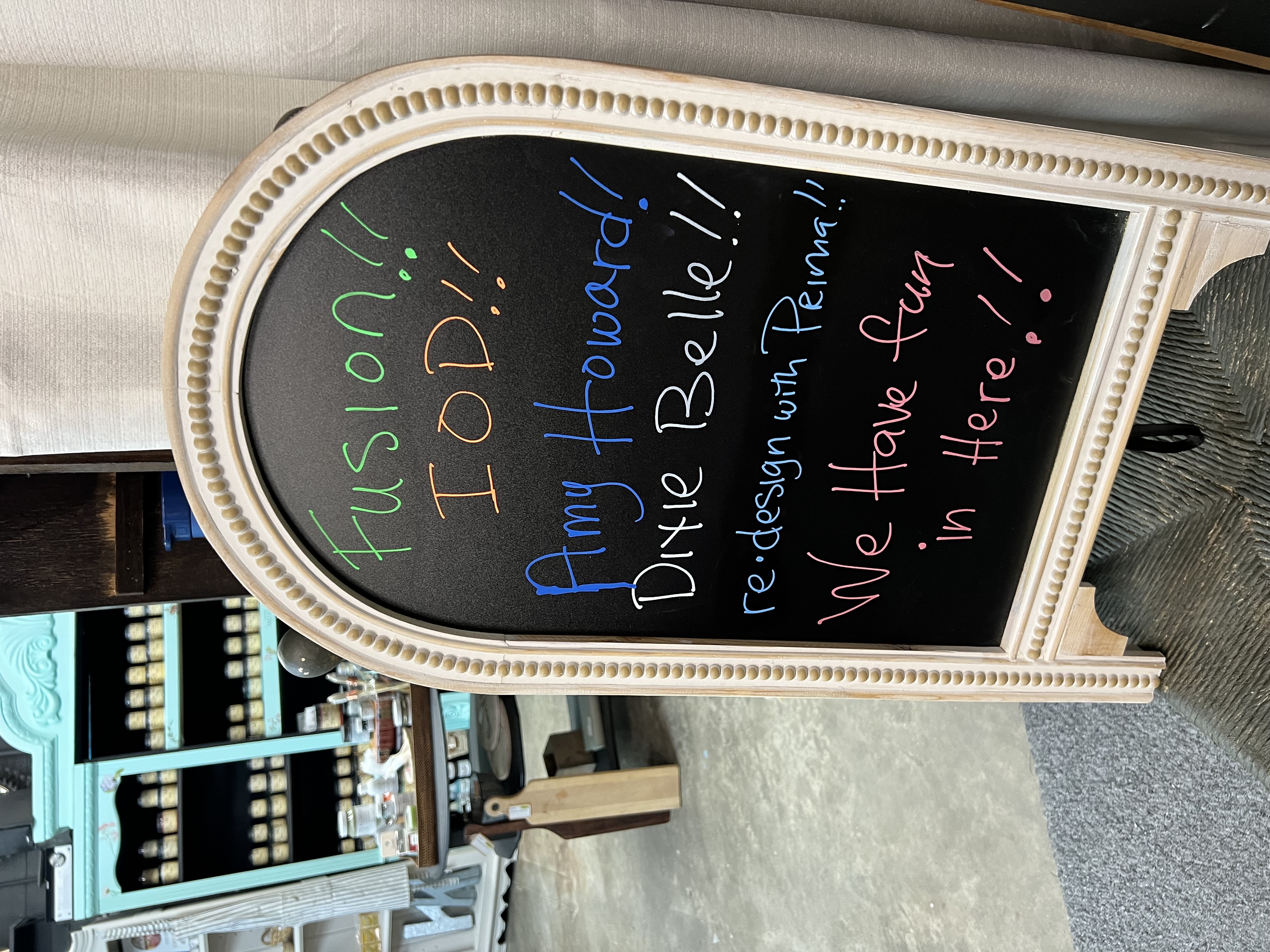Woman painting a colorful abstract floral canvas during an art class.