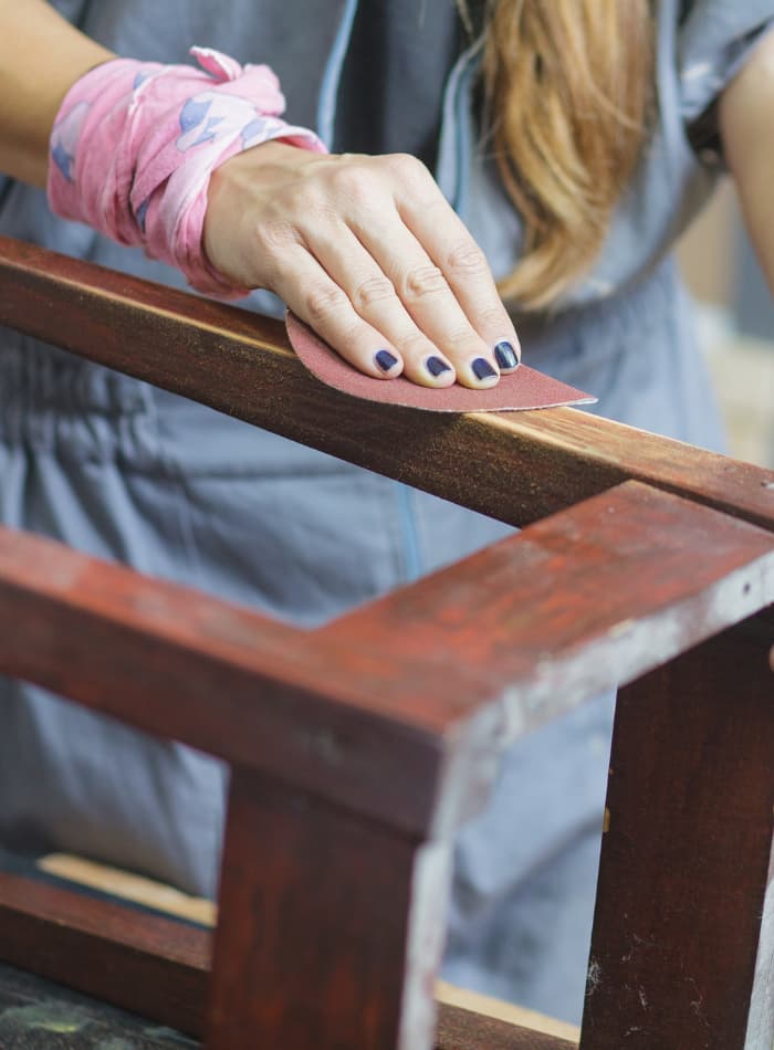 Woman painting a colorful abstract floral canvas during an art class.