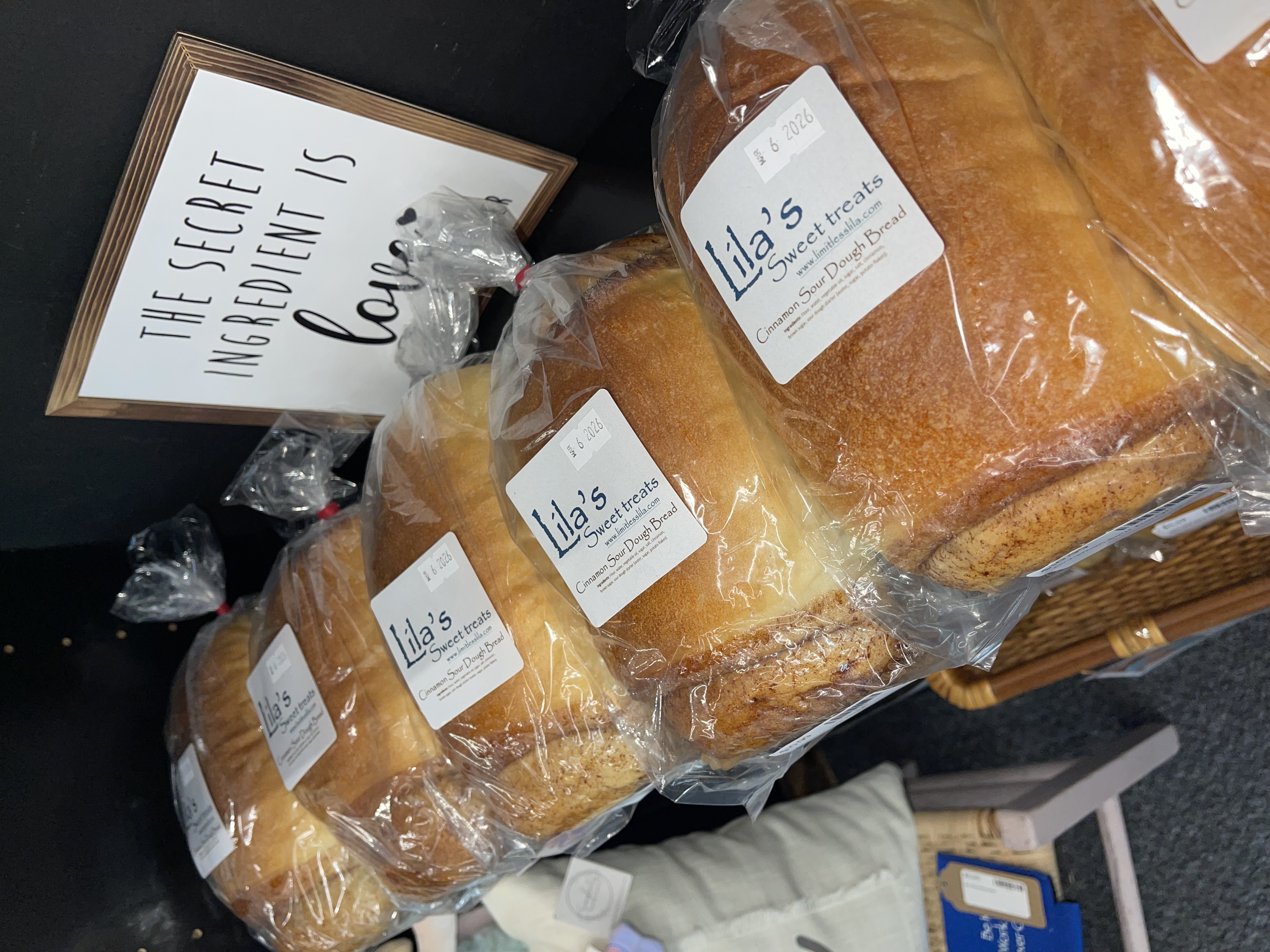 Vendor booth filled with vintage home decor, furniture, and accessories, including lamps, artwork, and dishes.