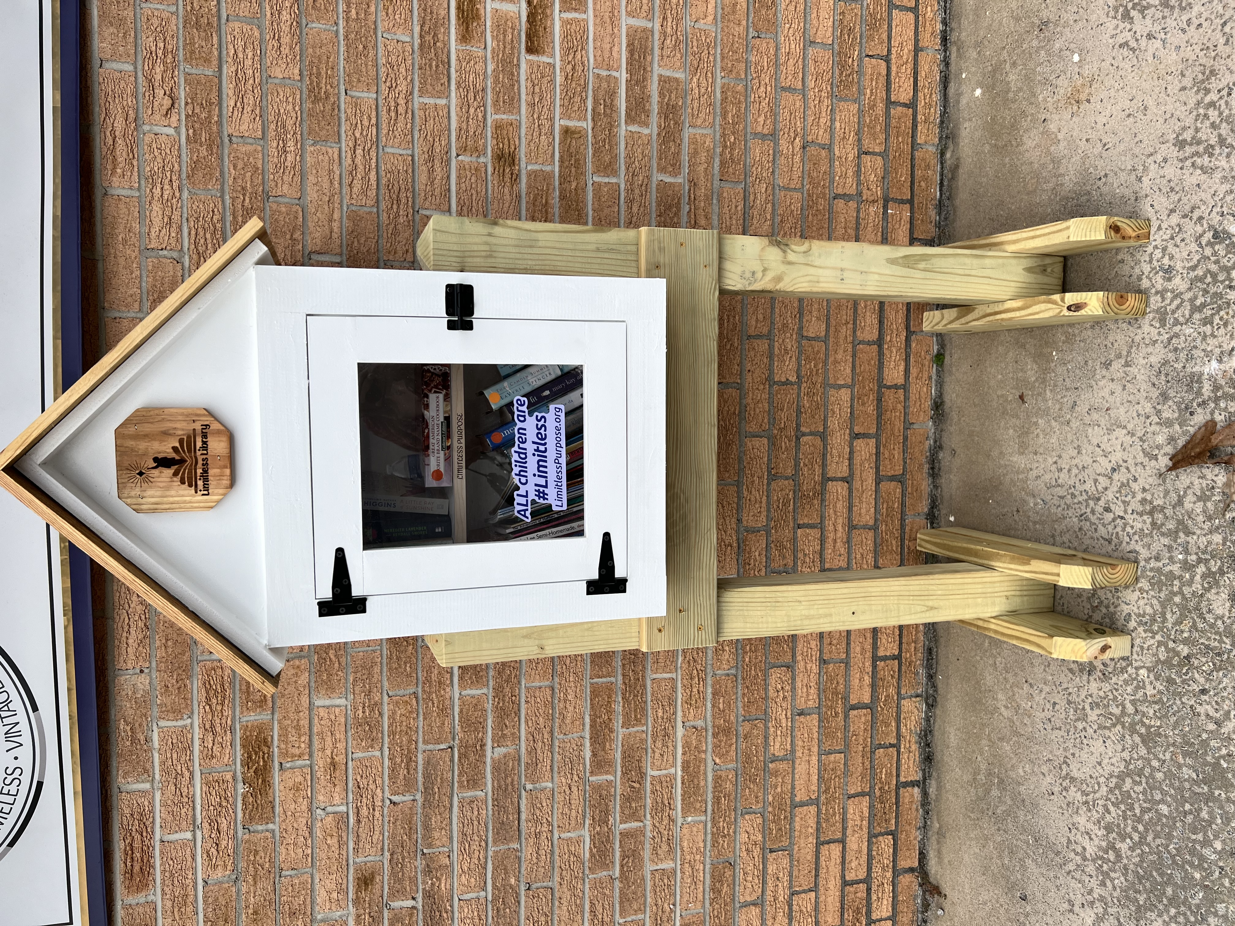 Vendor booth filled with vintage home decor, furniture, and accessories, including lamps, artwork, and dishes.