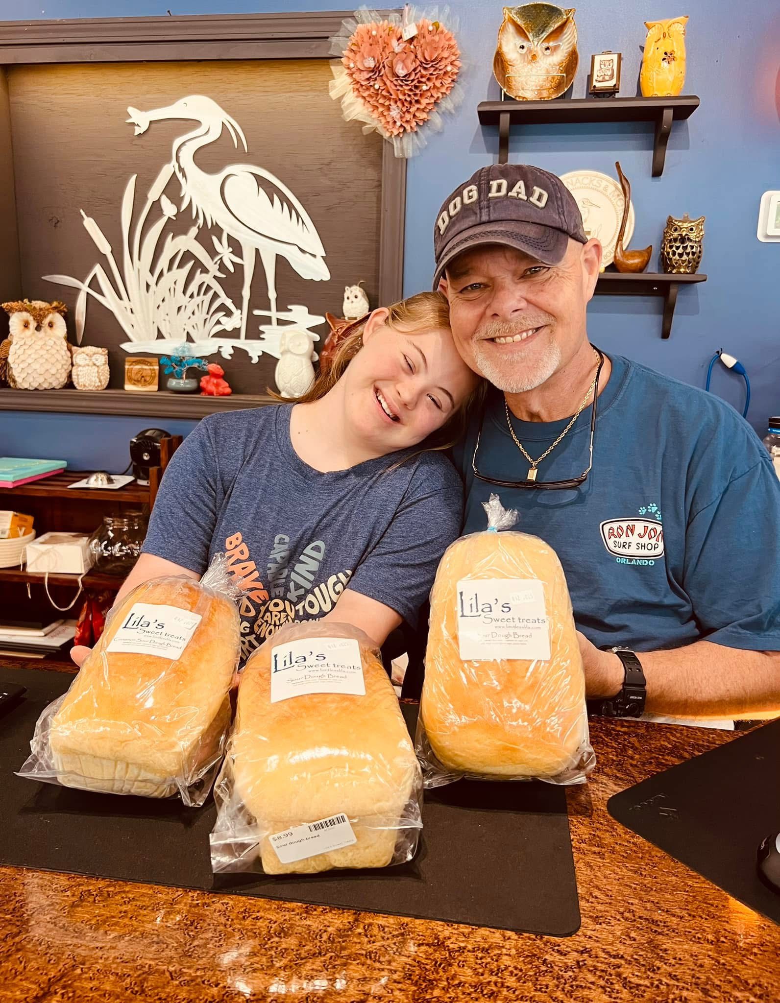 Vendor booth filled with vintage home decor, furniture, and accessories, including lamps, artwork, and dishes.