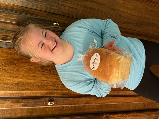 Vendor booth filled with vintage home decor, furniture, and accessories, including lamps, artwork, and dishes.