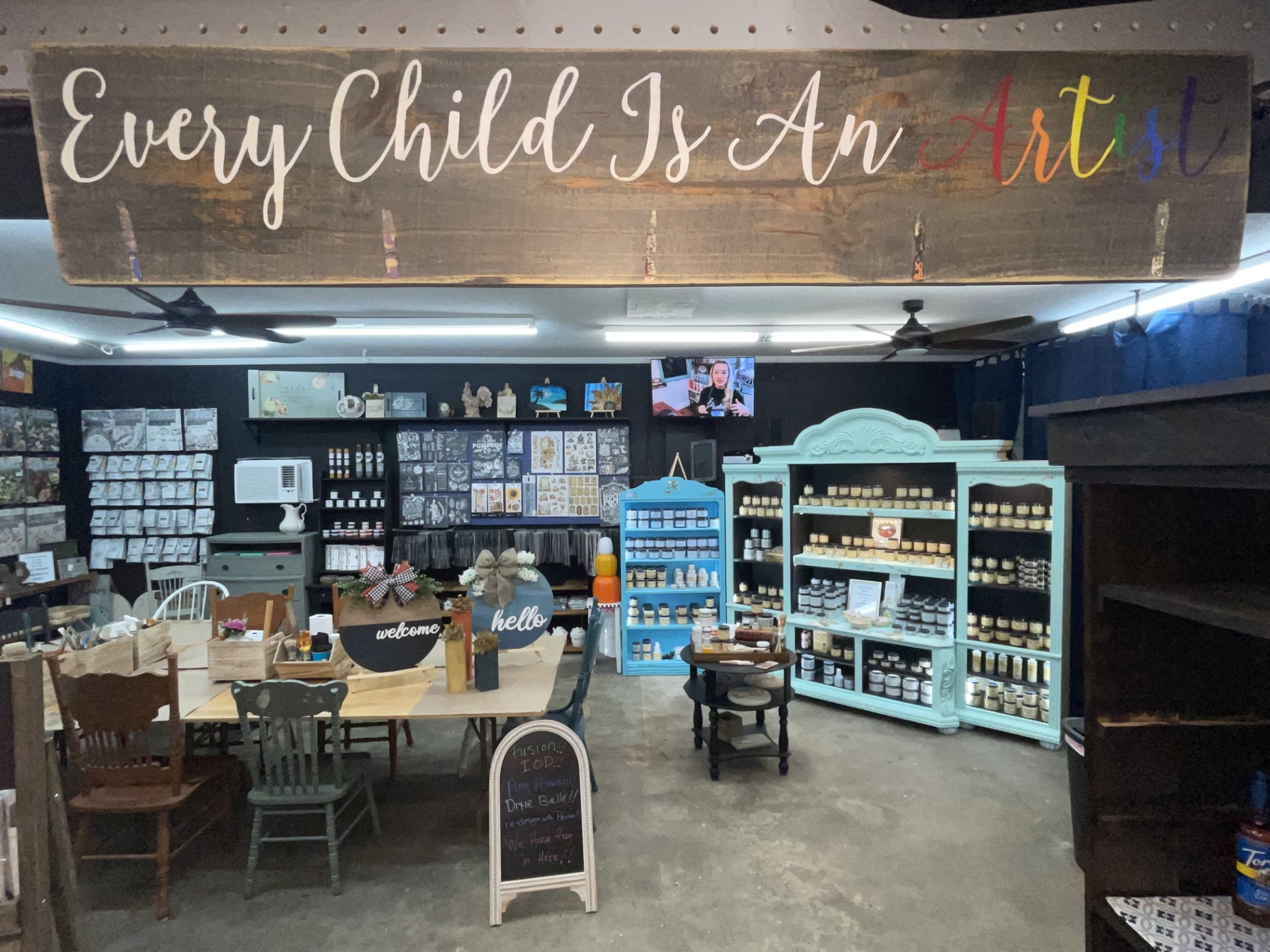 Group painting session with women working on black-and-white animal portraits.