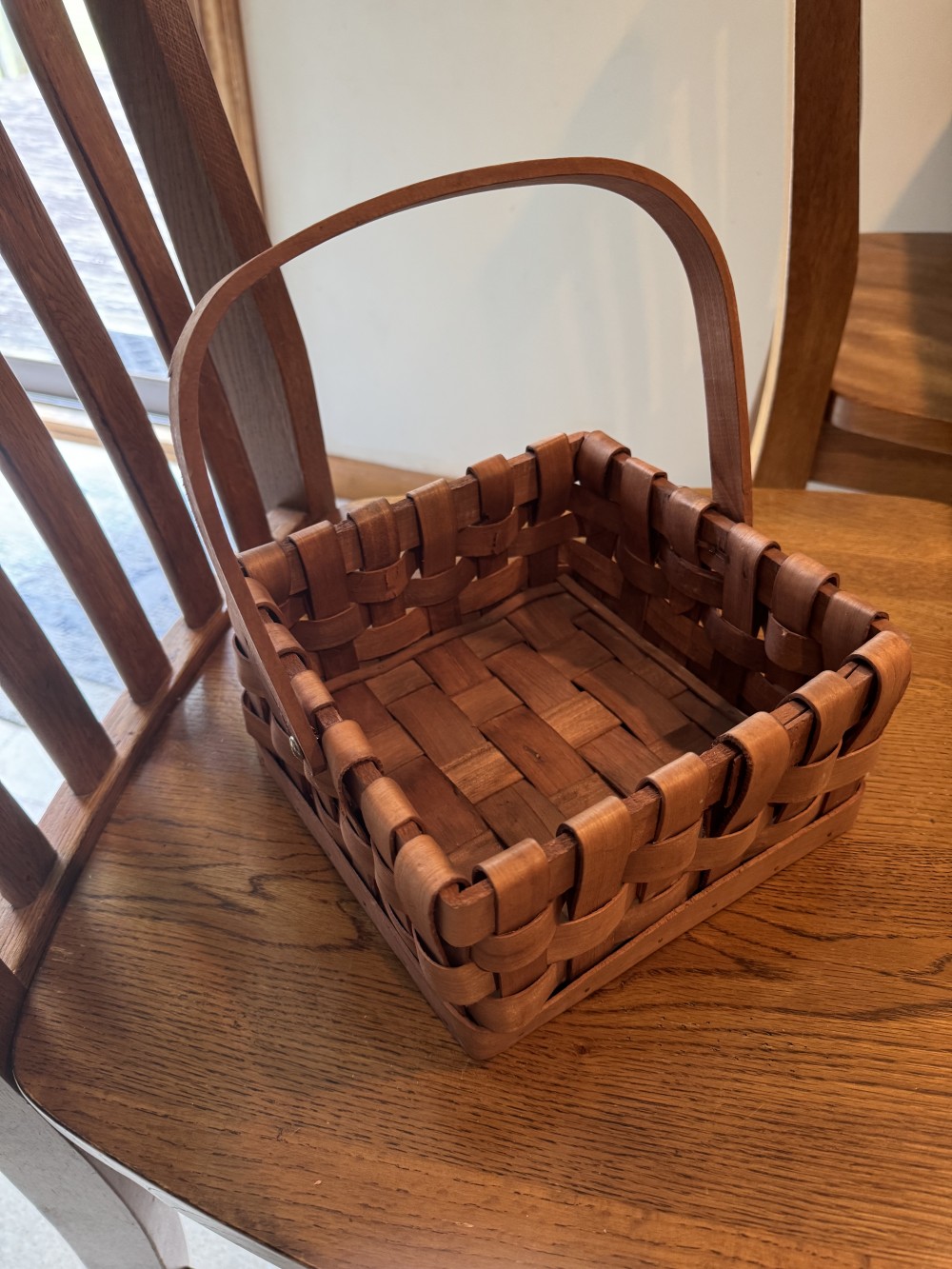 Woven wooden basket. 8 inches square.