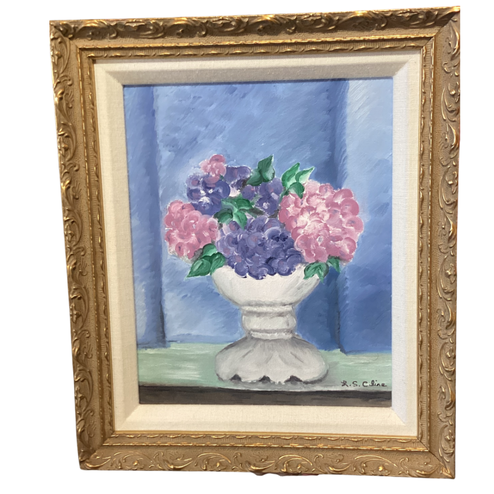 Framed watercolor painting featuring a sstill life of pink and purple flowers 