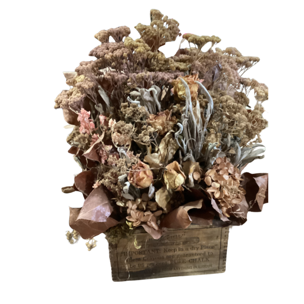 Rustic bouquet of dried flowers arranged in a wooden box