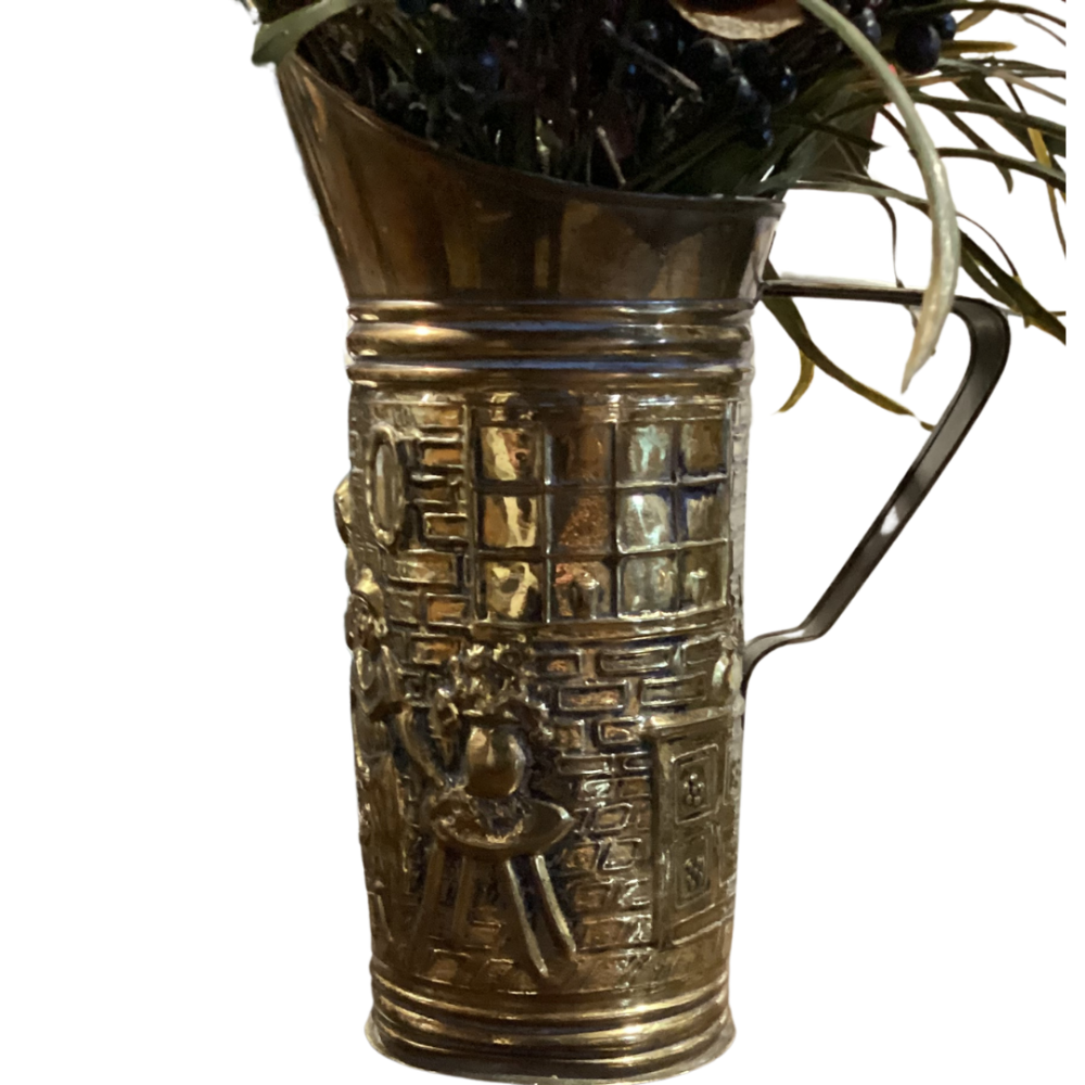 Antique brass jug of the nobility with floral arrangement