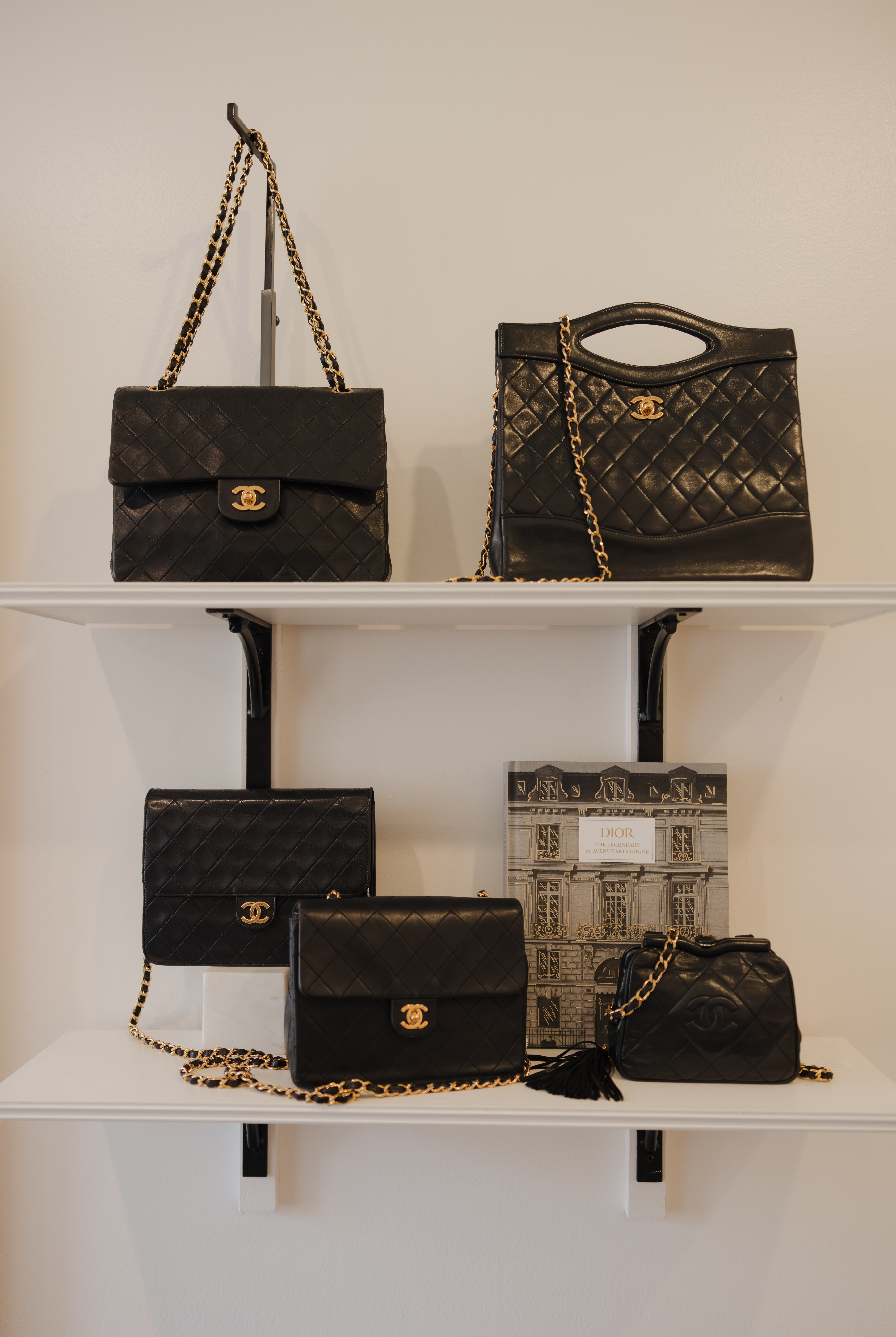 Three luxury handbags, a LV wallet, and a pair of slip on shoes.