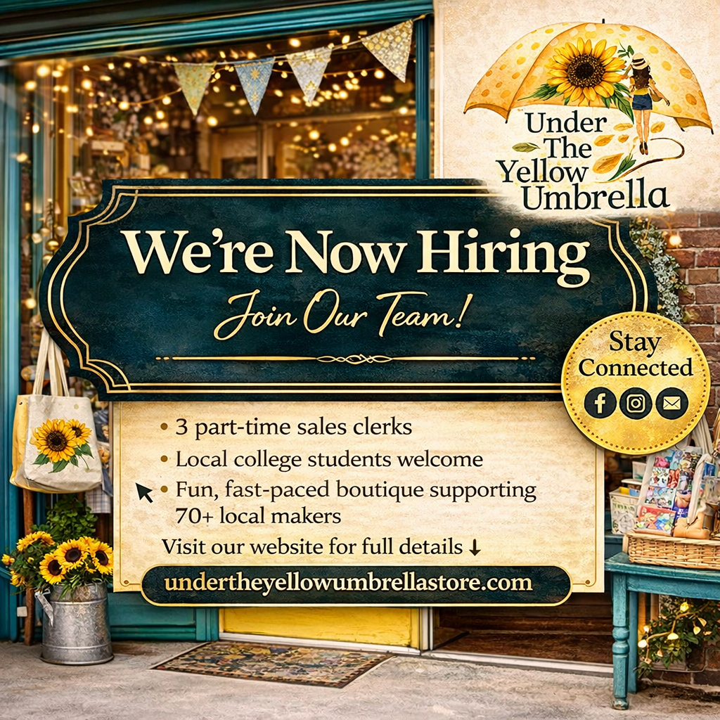 Photo of the Under the Yellow Umbrella sign outside of their store.