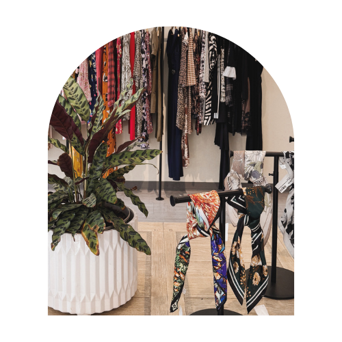 Patterned scarves and accessories displayed inside The Curated Closet boutique.