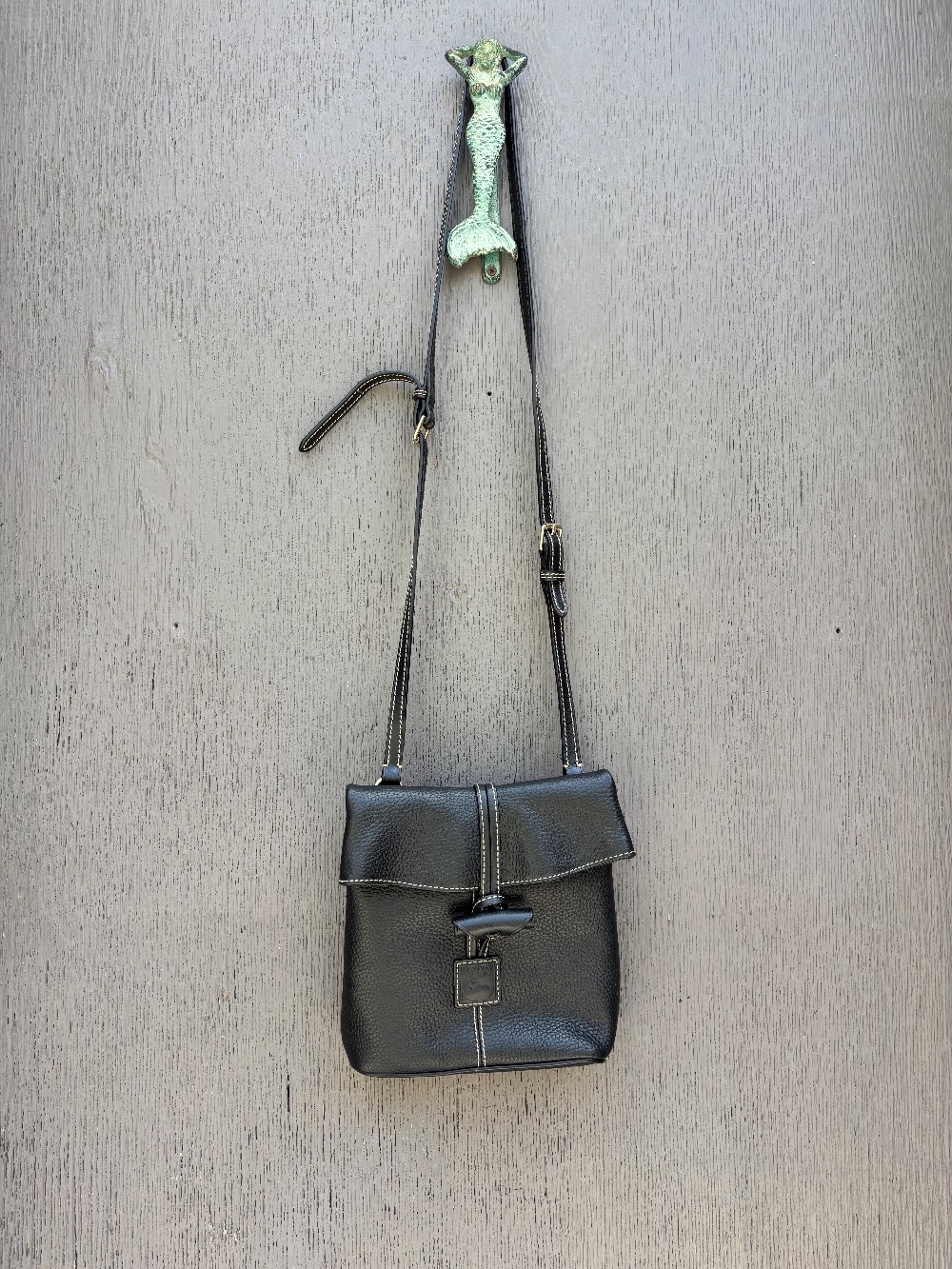 Dooney & Bourke black pebbled toggle crossbody