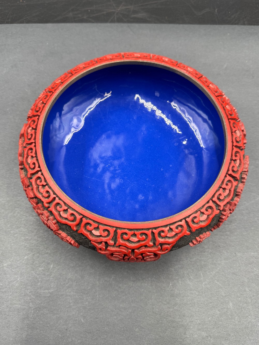 Chinese Cinnabar Style Bowl with Red Raised Carving on Black Ground, Blue Enamel Interior