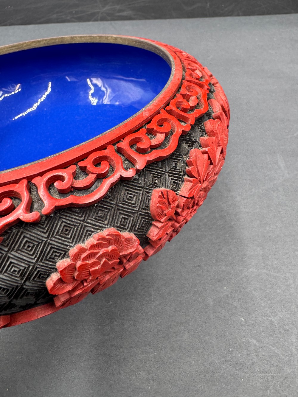 Chinese Cinnabar Style Bowl with Red Raised Carving on Black Ground, Blue Enamel Interior