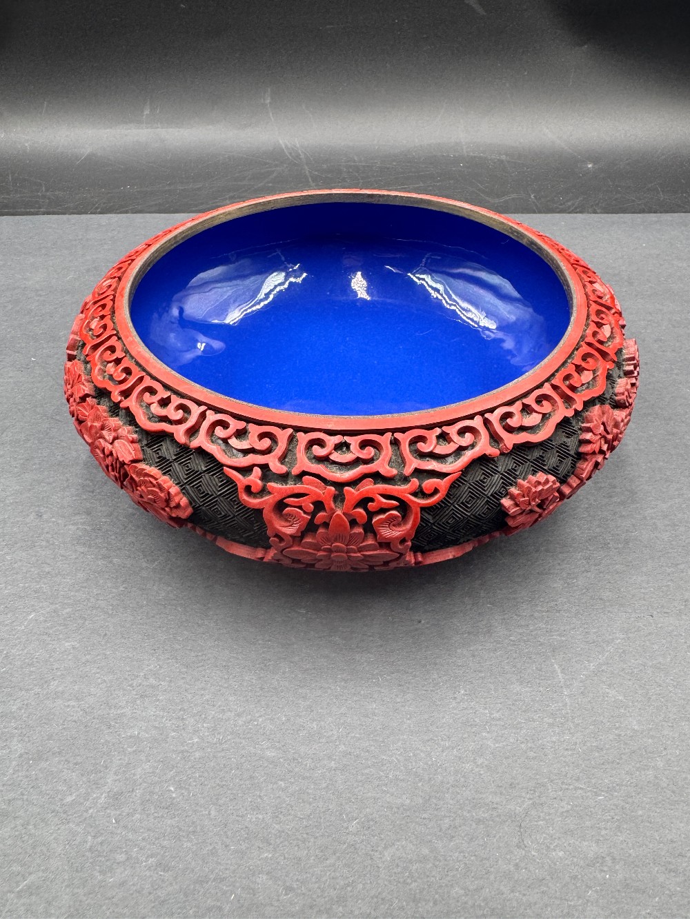 Chinese Cinnabar Style Bowl with Red Raised Carving on Black Ground, Blue Enamel Interior
