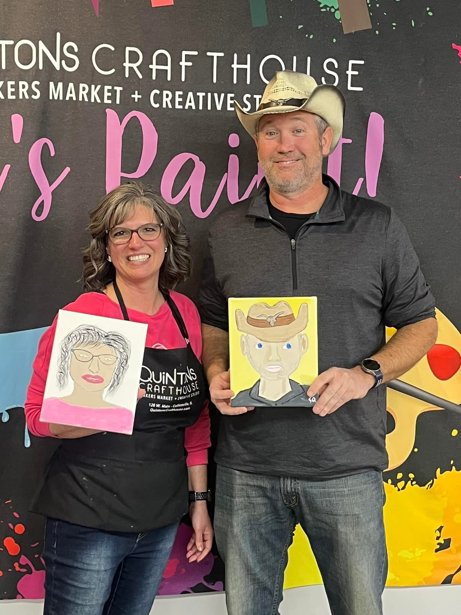 A couple posing with their self portrait painted art.