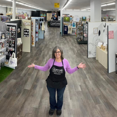 Suzie, the owner standing inside of her store.
