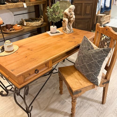 A wooden desk with iron legs inside Under the Arbor store.
