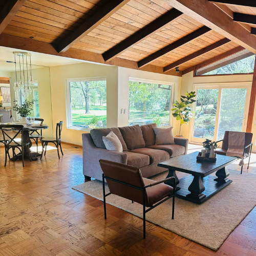 Staged living room set with high ceilings,  by the Under the Arbor team.