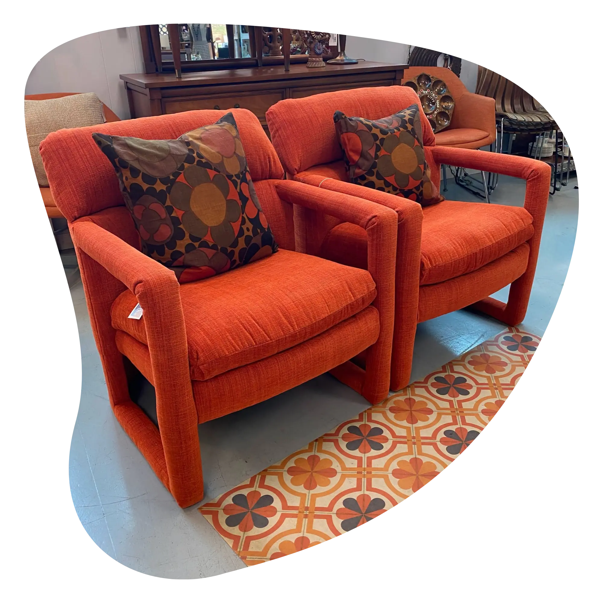 two orange vintage accent chairs side by side