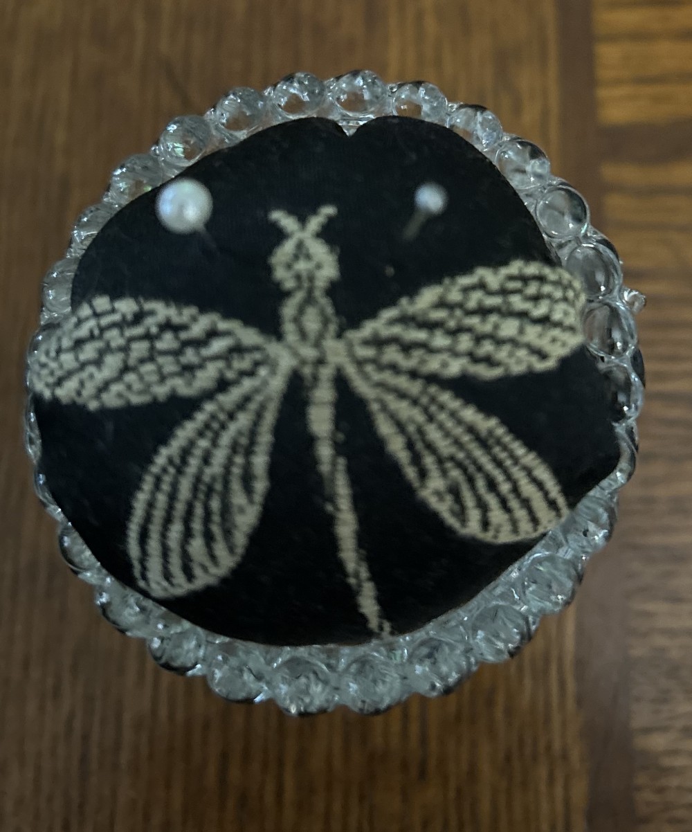 Pin cushion - Vintage pressed glass by Anchor Hocking hobnail clear glass (open salt cellar, toothpick holder, or small votive cup) with dragonfly on black fabric. (Sewing, crafts, straight pins.)