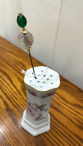 Antique porcelain hat pin holder. Pink rose motif.