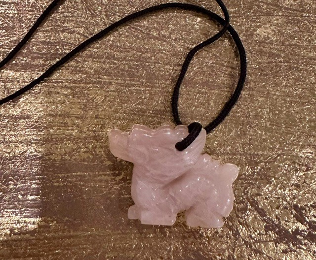 Carved rose quartz pixiu pendant with black cord