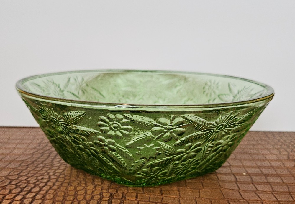 Vintage Indiana Glass bowl features a raised pineapple and floral pattern in a vibrant green color.