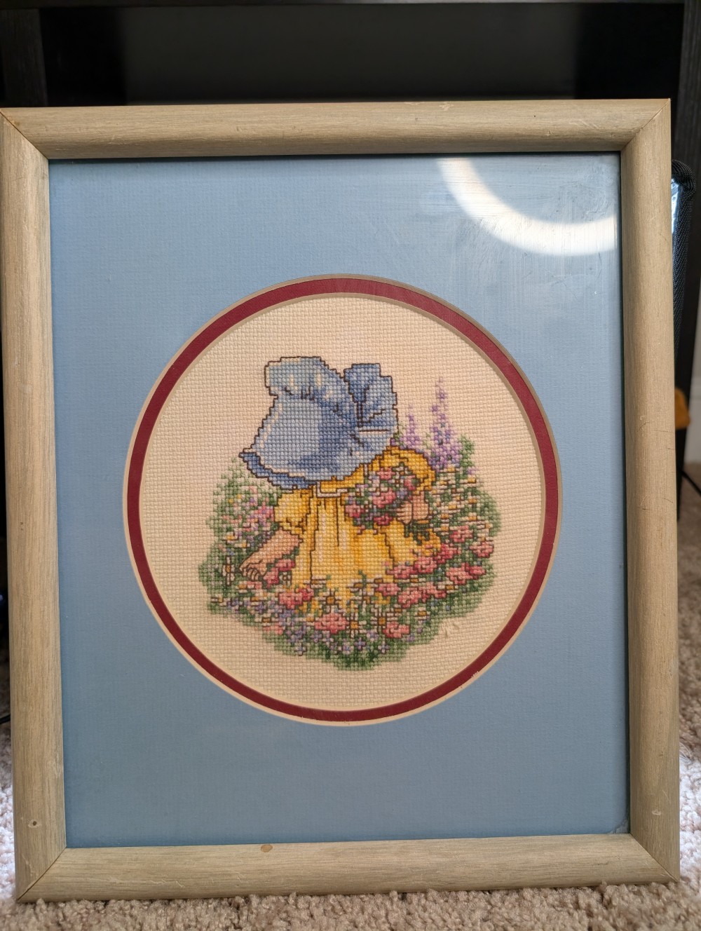 Framed 11x13 cross-stitch girl in bonnet picking flowers