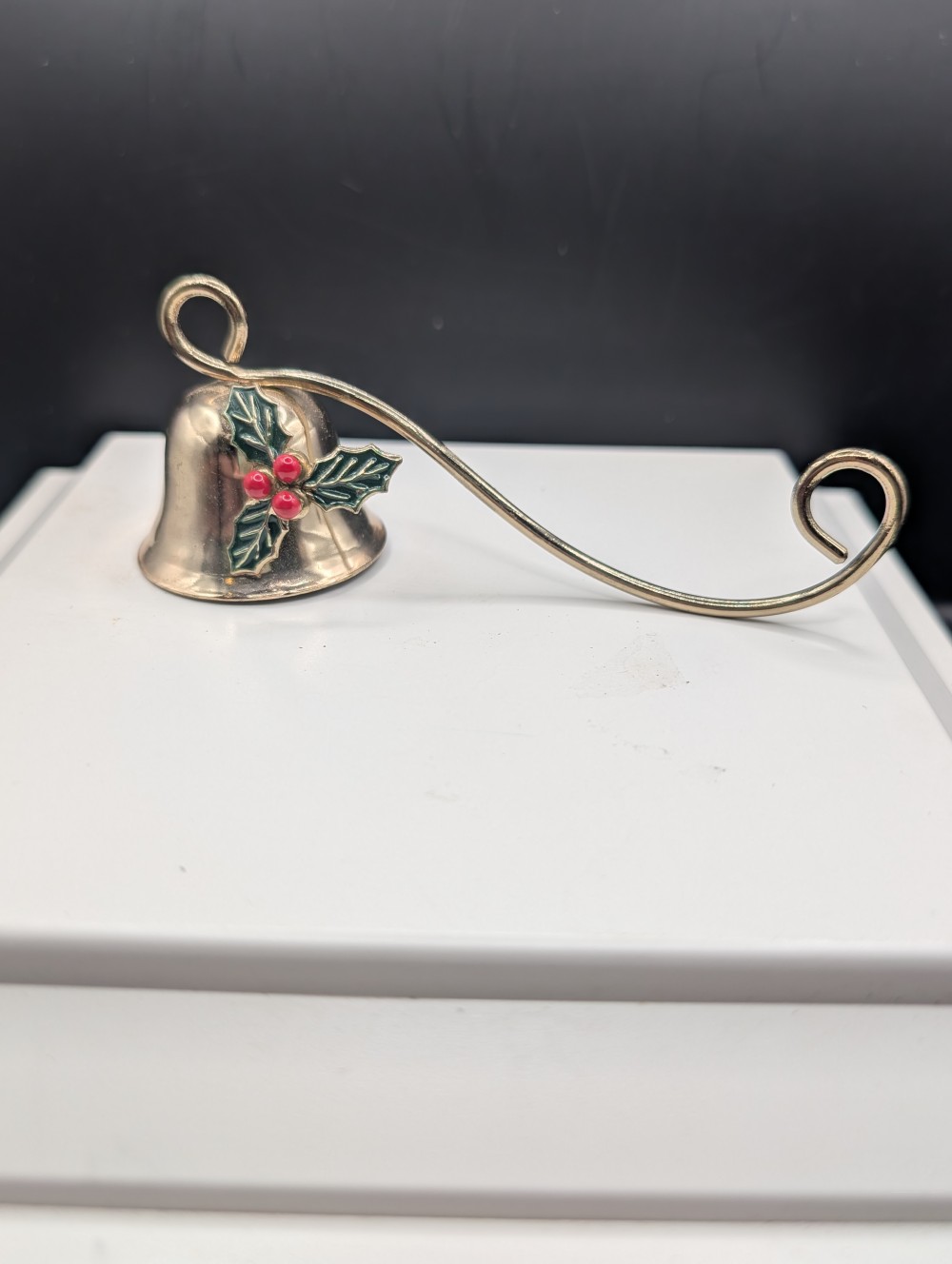 Metal candle snuffer with holly leaves