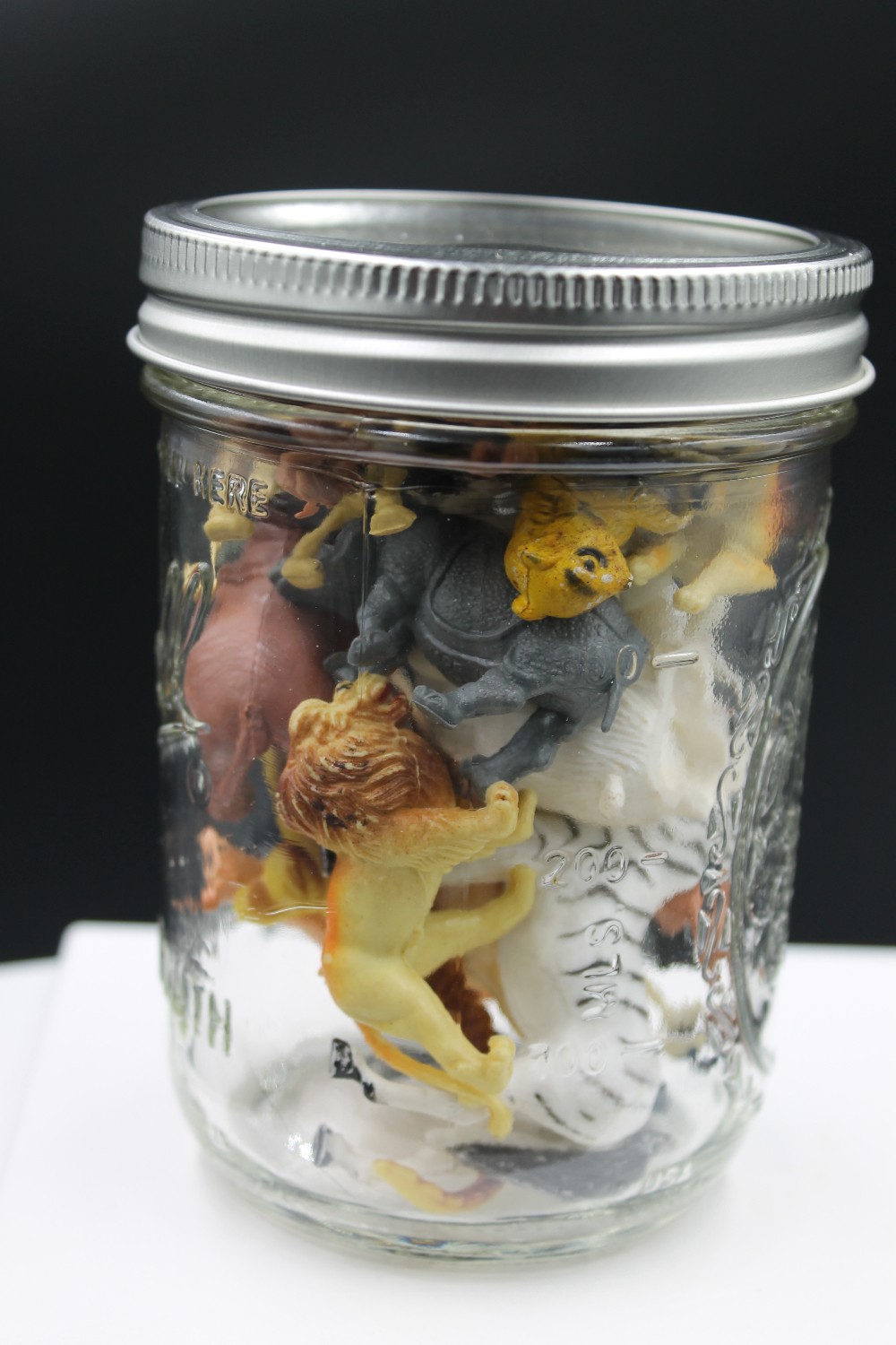 Jar of miniature wildlife animal figurines