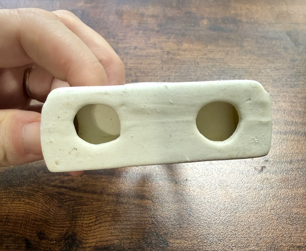 Ceramic prayer hands in frame