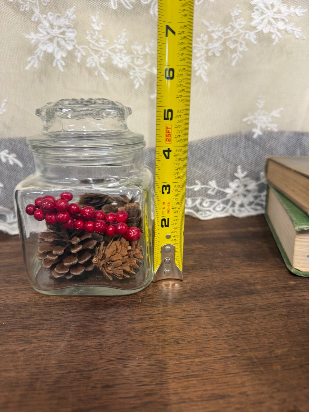 Square Glass Jar with Lid Filled with Pinecones and Red Berries