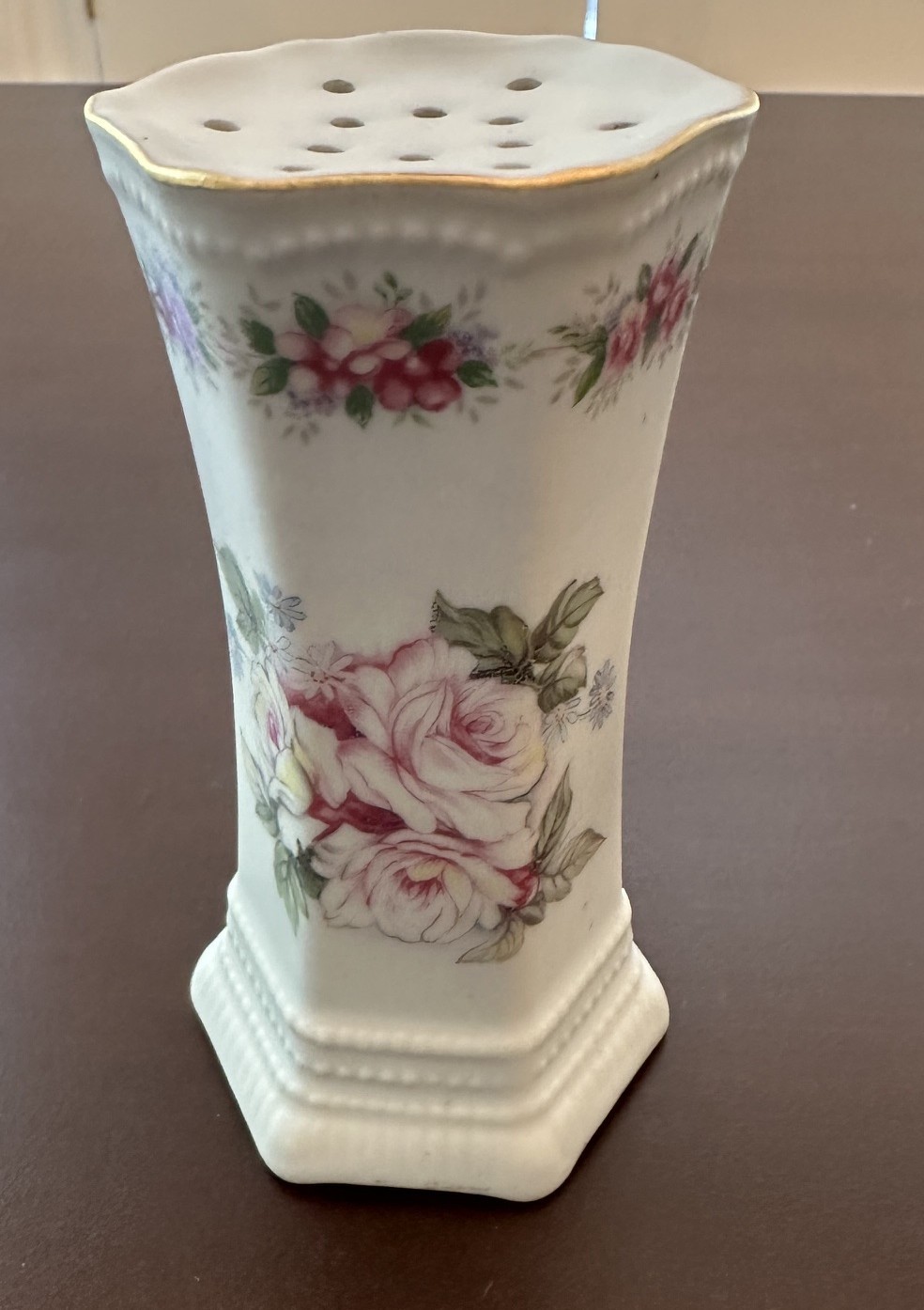 Antique porcelain hat pin holder. Pink rose motif.