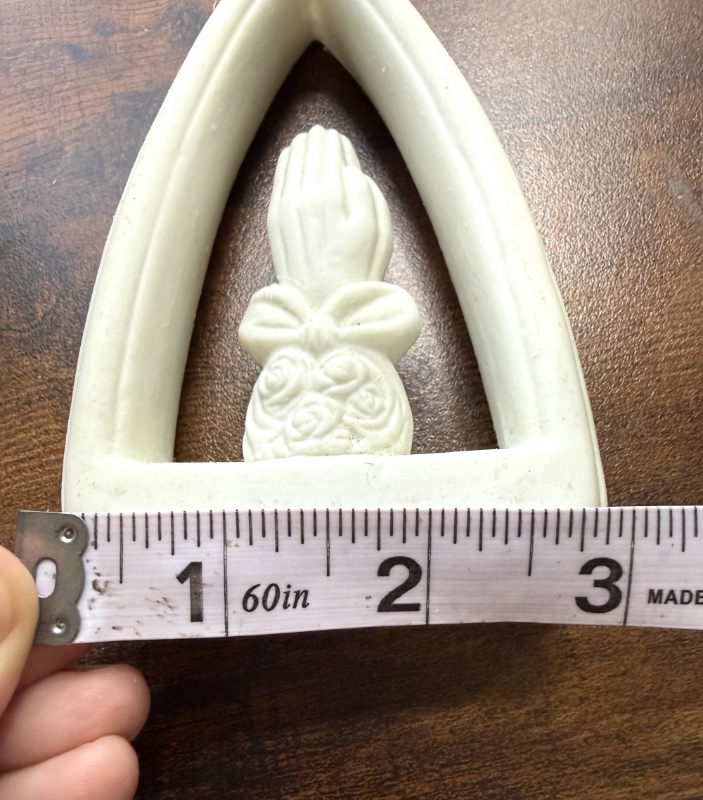 Ceramic prayer hands in frame