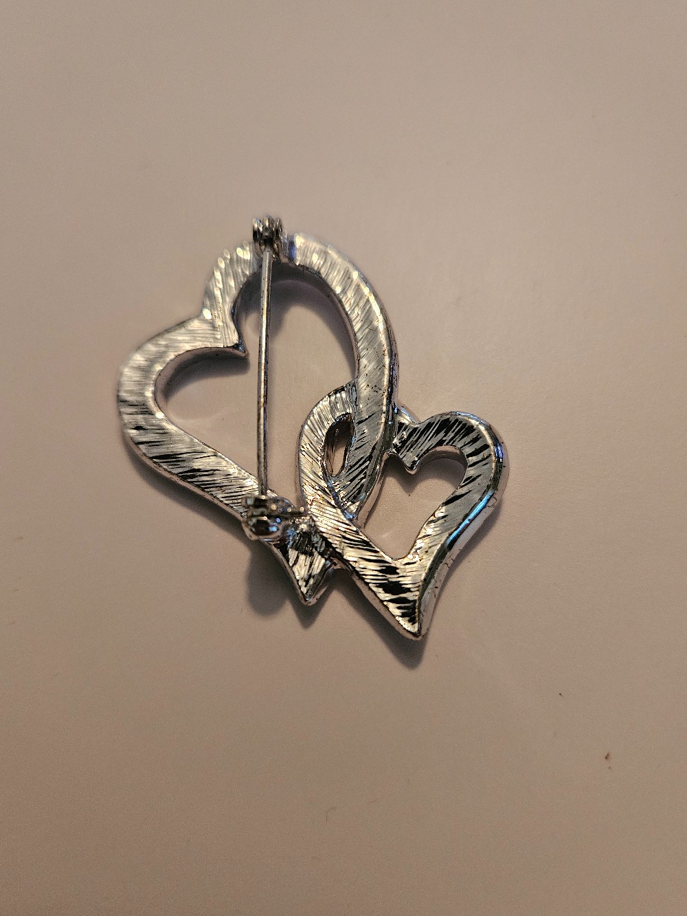 silver-tone interlocking heart brooch