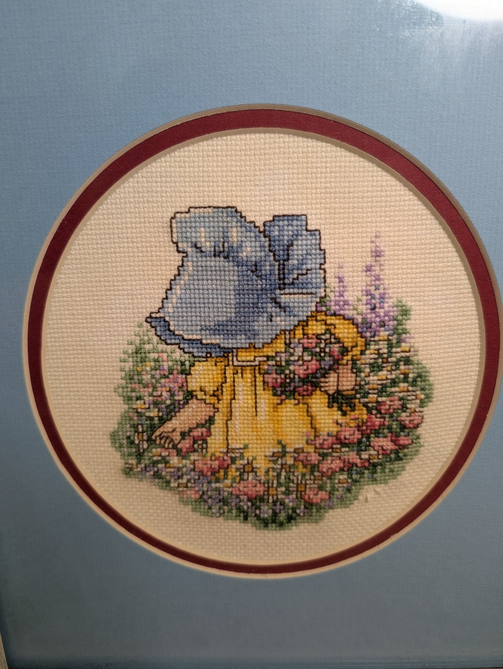 Framed 11x13 cross-stitch girl in bonnet picking flowers