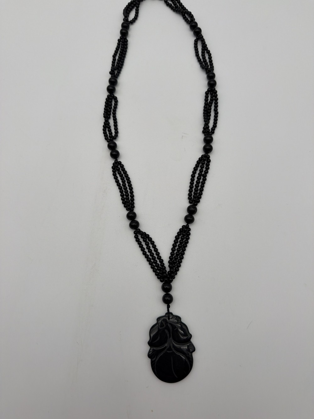 Vintage Black Glass Triple-Strand Beaded Necklace with Carved Peach Pendant