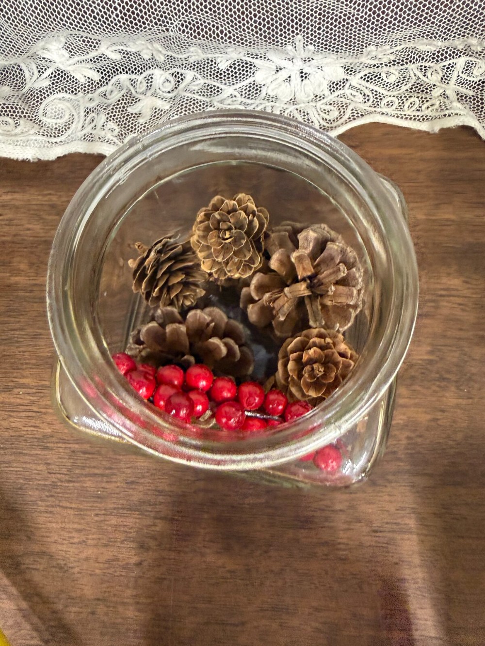 Square Glass Jar with Lid Filled with Pinecones and Red Berries