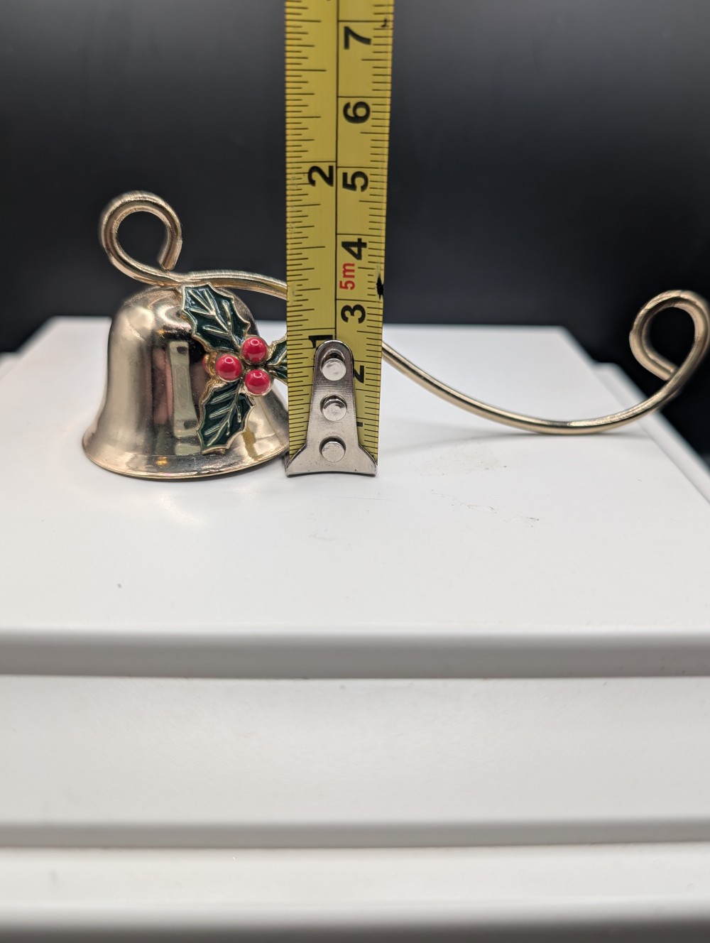 Metal candle snuffer with holly leaves