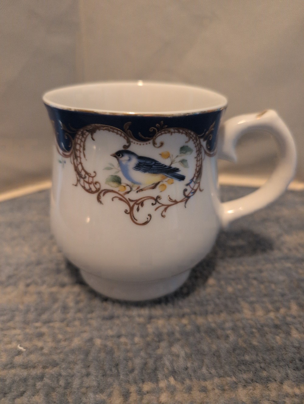 Blue and gold bird mug