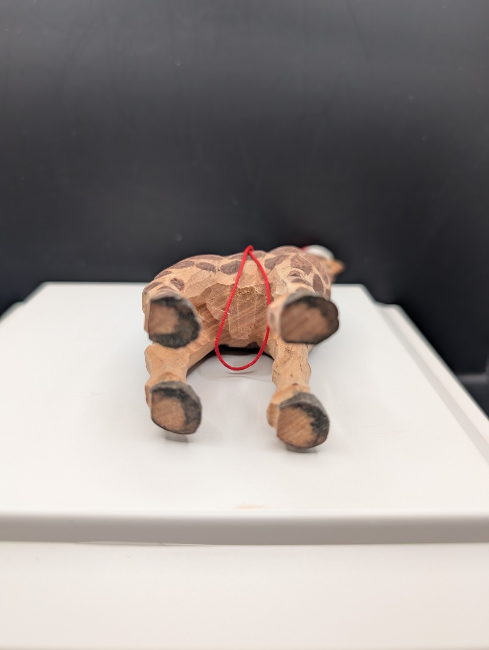Carved wooden giraffe with Santa hat