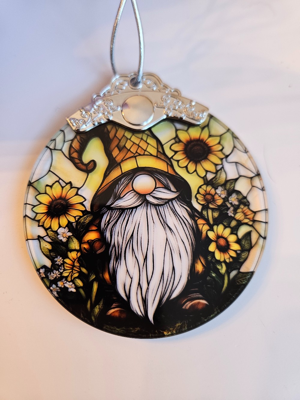 This sunflower gnome suncatcher features a round stained glass design