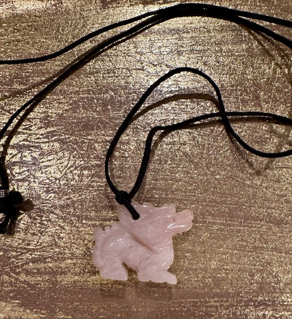 Carved rose quartz pixiu pendant with black cord
