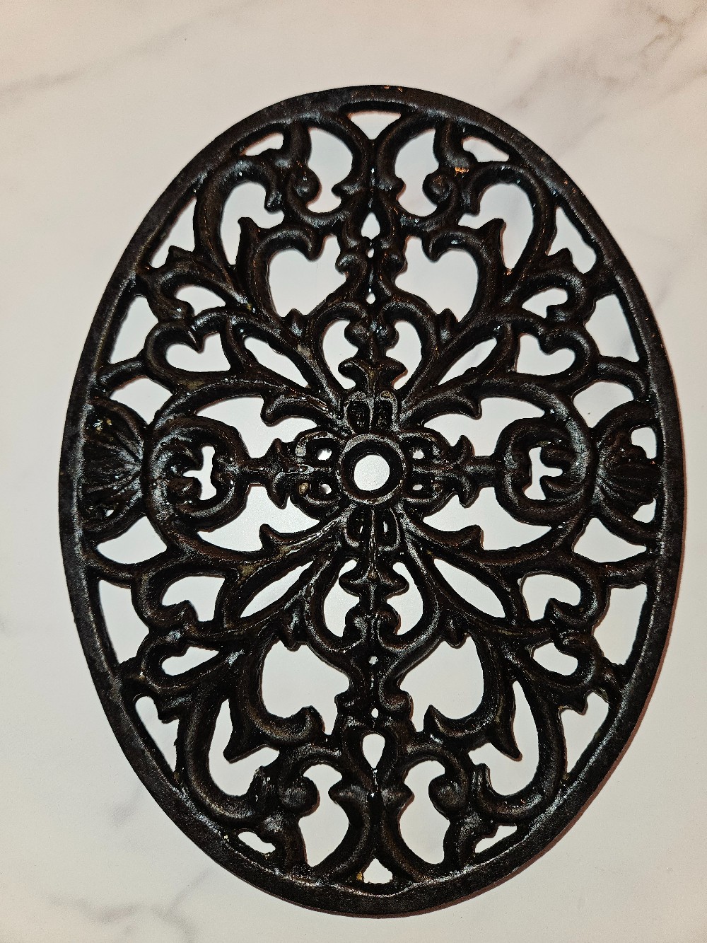 Black cast iron oval trivet