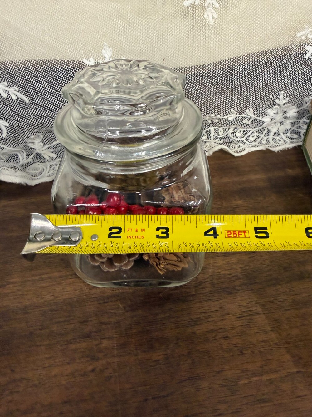 Square Glass Jar with Lid Filled with Pinecones and Red Berries