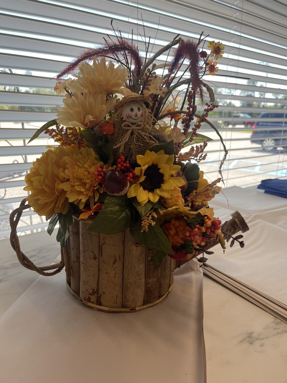 Fall flowers in wooden watering can