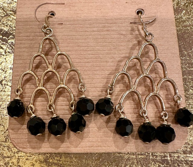Gold tone chandelier earrings with black faceted beads