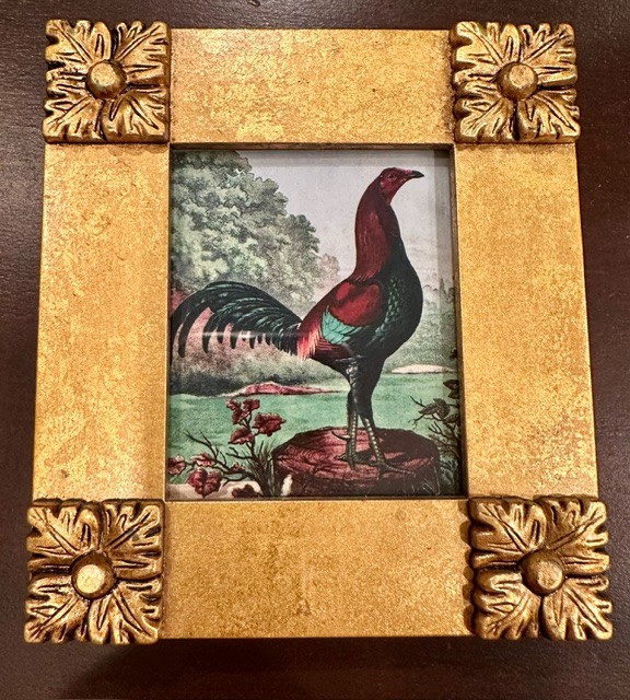 Vint-style gamecock print in ornate gold tone frame with floral corners. Easel back.