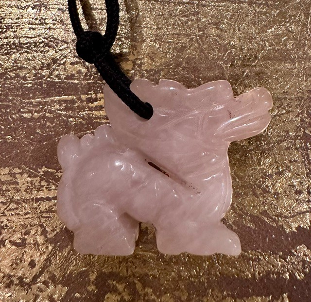 Carved rose quartz pixiu pendant with black cord